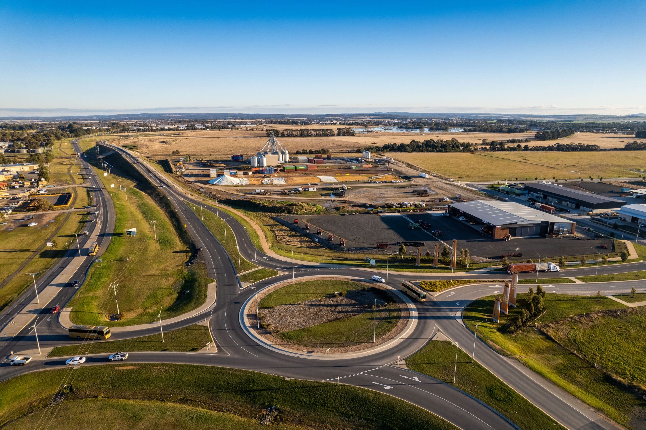 Drone aerial view of Ballarat West Employment Zone roundabout with roads, industrial buildings and farmland