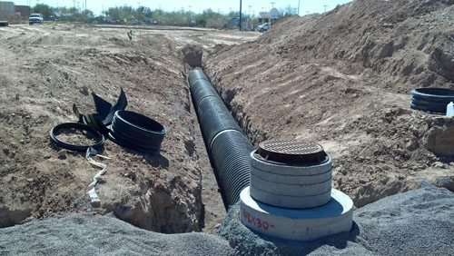 Construction trench with sewer pipeline and manhole for ACHM cultural heritage project assessment context
