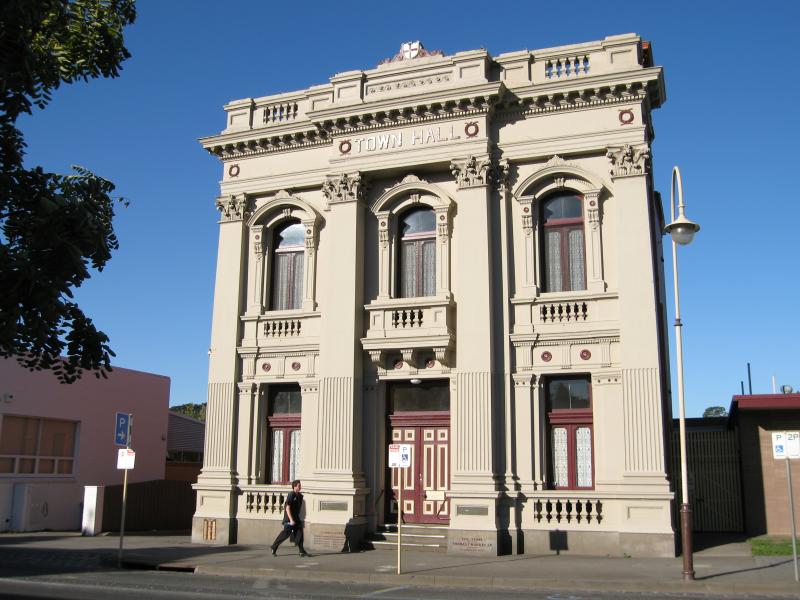 Historic Town Hall building with ornate façade, arched windows and clear blue sky